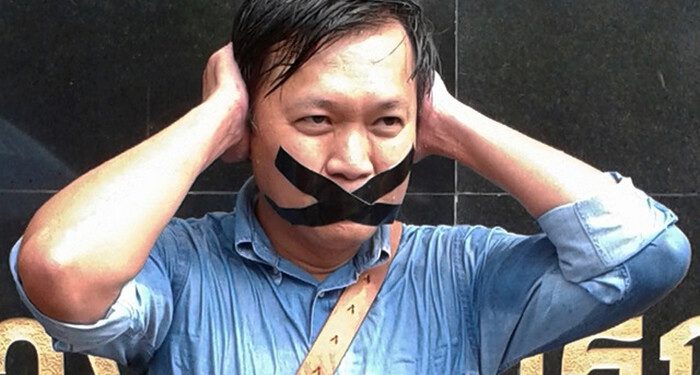 Pravit Rojanaphruk, an outspoken Thai columnist for the English-language daily The Nation, poses for  photograph while being called to report himself to the ruling military along with other journalists in Bangkok, Thailand Sunday, May 25, 2014. A spokesman for Thailand's coup leaders said Sunday that democracy had caused "losses" for the country, as the junta sought to combat growing international condemnation and hundreds of protesters angrily confronted soldiers in central Bangkok. (AP Photo)