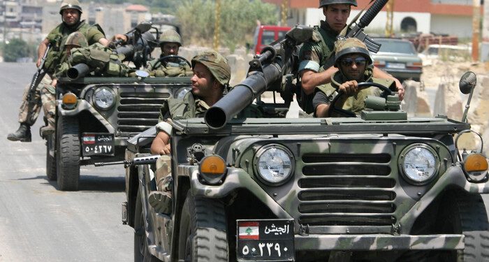 NAHR AL-BARED, LEBANON: Lebanese soldiers patrol in the outskirts of the Palestinian refugee camp of Nahr al-Bared in northern Lebanon, 04 June 2007. The eruption of deadly violence at a second Palestinian refugee camp in Lebanon has raising fears of violence spreading through the country's dozen camps that have become breeding grounds for extremism. AFP PHOTO / RAMZI HAIDAR (Photo credit should read RAMZI HAIDAR/AFP/Getty Images)