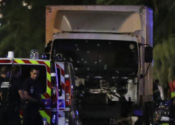 Police officers stand near a van, with its windscreen riddled with bullets, that ploughed into a crowd leaving a fireworks display in the French Riviera town of Nice on July 14, 2016.
Up to 30 people are feared dead and over 100 others were injured after a van drove into a crowd watching Bastille Day fireworks in the French resort of Nice on July 14, a local official told French television, describing it as a "major criminal attack". / AFP PHOTO / VALERY HACHEVALERY HACHE/AFP/Getty Images