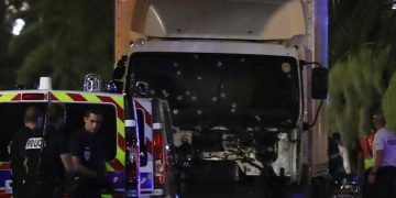 Police officers stand near a van, with its windscreen riddled with bullets, that ploughed into a crowd leaving a fireworks display in the French Riviera town of Nice on July 14, 2016.
Up to 30 people are feared dead and over 100 others were injured after a van drove into a crowd watching Bastille Day fireworks in the French resort of Nice on July 14, a local official told French television, describing it as a "major criminal attack". / AFP PHOTO / VALERY HACHEVALERY HACHE/AFP/Getty Images