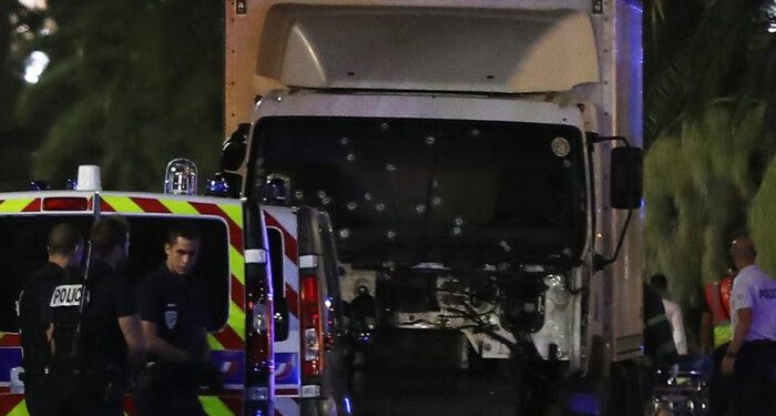 Police officers stand near a van, with its windscreen riddled with bullets, that ploughed into a crowd leaving a fireworks display in the French Riviera town of Nice on July 14, 2016.
Up to 30 people are feared dead and over 100 others were injured after a van drove into a crowd watching Bastille Day fireworks in the French resort of Nice on July 14, a local official told French television, describing it as a "major criminal attack". / AFP PHOTO / VALERY HACHEVALERY HACHE/AFP/Getty Images