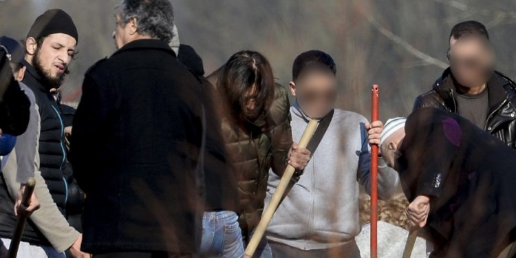 Relatives and friends, including Abid Aberkan (L), attend the burial ceremony of Brahim Abdeslam, one of the attackers of the November 13 Paris attacks, at the interdenominational cemetery of Schaerbeek in Brussels on March 17, 2016.
Aberkan was arrested on March 19 for sheltering key Paris attacks suspect Salah Abdeslam in Molenbeek and charged with "participating in a terrorist group" and hiding a fugitive. / AFP / Belga / STRINGER / Belgium OUT