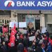 People stage a protest against the seizure of the Islamic Bank Asya, in front of a Bank Asya branch in downtown Ankara on February 4, 2015. Turkey on February 4 defended the seizure of an Islamic bank allied to an arch-foe of President Recep Tayyip Erdogan, the latest crackdown against US-exiled cleric Fethullah Gulen. Bank Asya has suffered major losses since last year after becoming embroiled in a bitter feud between Erdogan and his former ally Gulen, whom the president accuses of seeking to overthrow him. The placard (C) reads "boxes of money were not enough, now it's time to attack Bank Asya".  AFP PHOTO / ADEM ALTAN        (Photo credit should read ADEM ALTAN/AFP/Getty Images)