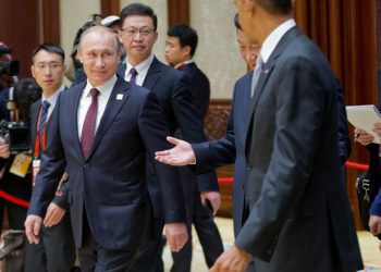 Russian President Vladimir Putin, left, Chinese President Xi Jinping, center, and U.S. President Barack Obama are seen arriving at the the Asia-Pacific Economic Cooperation (APEC) Summit plenary session at the International Convention Center, Yanqi, Tuesday, Nov. 11, 2014 in Beijing. (AP Photo/Pablo Martinez Monsivais, Pool)