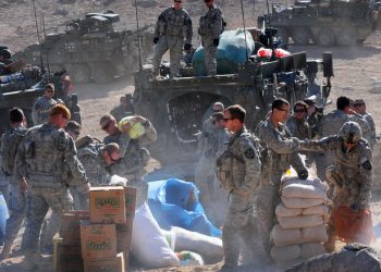 U.S. Soldiers with Charlie Company, 1st Battalion, 17th Regiment unload Humanitarian aid for distribution to the town of Rajan Kala, Afghanistan Dec. 05, 2009. Charlie Company used their Stryker armored vehicles to move the Humanitarian aid from the Joint District Community Center to the town of Rajan Kala. (U.S. Air Force photo by Tech. Sgt. Francisco V. Govea II/Released)