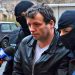 Marcel Lazar Lehel, 40, is escorted by masked policemen in Bucharest, after being arrested in Arad, 550 km (337 miles) west of Bucharest January 22, 2014. Lehel is allegedly the hacker using the nicknames "Guccifer" and "The Small Fume" and is suspected to have broken into several e-mail accounts of various politicians and celebrities and the head of Romania's Intelligence Service George Maior. REUTERS/Mediafax/Silviu Matei (ROMANIA - Tags: CRIME LAW) THIS IMAGE HAS BEEN SUPPLIED BY A THIRD PARTY. IT IS DISTRIBUTED, EXACTLY AS RECEIVED BY REUTERS, AS A SERVICE TO CLIENTS. ROMANIA OUT. NO COMMERCIAL OR EDITORIAL SALES IN ROMANIA