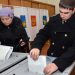 A Russian navy officer and a woman cast their ballots during the parliamentary election in Vladivostok on December 4, 2011. Russians in the Far East began voting in key parliamentary polls expected to hand victory to Vladimir Putin's party amid claims of campaign fraud and unprecedented intimidation of observers. AFP PHOTO / GENNADY SHISHKIN