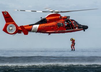 A Coast Guard rescue swimmer conducts a freefall direct deployment from an HH-65D Dolphin helicopter from Coast Guard Air Station Los Angeles, April 7, 2015. Coast Guard aviation survival technicians fill the role as rescue swimmers during flight operations and are responsible for all lifesaving equipment onboard the helicopter. (U.S. Coast Guard photograph by Petty Officer 1st Class Adam Eggers)