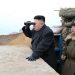 FILE - In this March 7, 2013 file photo released by the Korean Central News Agency (KCNA) and distributed by the Korea News Service, North Korean leader Kim Jong Un uses a pair of binoculars to look at the South's territory from an observation post at the military unit on Jangjae islet, located in the southernmost part of the southwestern sector of North Korea's border with South Korea. For the outside world, North Korea's message is largely doom and gloom: bombastic threats of nuclear war, amateur-looking videos showing U.S. cities in flames, digitally altered photos of military drills. But a domestic audience gets a parallel and decidedly softer dose of propaganda - and one with potentially higher stakes for the country's young leader. (AP Photo/KCNA via KNS, File)