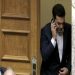 Greece's Prime Minister Alexis Tsipras speaks from his mobile phone during emergency Parliament session for the governments proposed referendum in Athens, Saturday, June 27, 2015. Greece's place in the euro currency bloc looked increasingly shaky on Saturday, when eurozone countries rejected a monthlong extension to its bailout program and the prime minister called for a risky popular vote on the country's financial future. (AP Photo/Petros Karadjias)