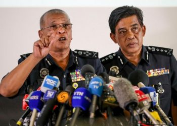 Deputy National Police Chief of Malaysia Noor Rashid Ibrahim, left, speaks as Selangor Police Chief Abdul Samah Mat listens during a press conference at the Bukit Aman national police headquarters in Kuala Lumpur, Malaysia, Sunday, Feb. 19, 2017.  Investigators are looking for four North Korean men who flew out of Malaysia the same day Kim Jong Nam, the North Korean ruler's outcast half brother, was apparently poisoned at an airport in Kuala Lumpur, Malaysian police said Sunday. (AP Photo/Vincent Thian)