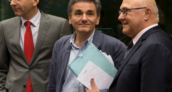 Newly appointed Greek Finance Minister Euclid Tsakalotos (C) is welcomed by Eurogroup President Jeroen Dijsselbloem (L) and French Finance Minister Michel Sapin at a euro zone finance ministers meeting on the situation in Greece in Brussels, Belgium, July 7, 2015. Greece faces a last chance to stay in the euro zone on Tuesday when Prime Minister Alexis Tsipras puts proposals to an emergency euro zone summit after Greek voters resoundingly rejected the austerity terms of a defunct bailout. REUTERS/Philippe Wojazer