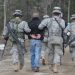 Alaska National Guard Soldiers escort a protestor away after assisting Anchorage Police to calm or detain rioters as part of the training scenario of exercise Vigilant Guard Ft. Richardson, Alaska, Wednesday April 28, 2010. Vigilant Guard is an annual, disaster-based training scenario that tests the coordination of National Guard units with local, state, regional, and national disaster preparedness organizations. (U.S. Air Force photo by Tech. Sgt. Brian E. Christiansen, North Carolina National Guard) (Released)