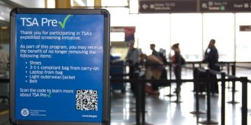 This undated image released by the Transportation Security Administration shows a sign promoting the TSA PreCheck program at at Reagan National Airport in Washington. The Transportation Security Administration's PreCheck program is open to some elite frequent fliers as well as travelers enrolled in one of the Customs & Border Protection's expedited entry programs: Global Entry, Nexus and Sentri. These travelers are considered less of a terrorist risk and therefore don't have to go through as stringent of a screening process.  (AP Photo/TSA)