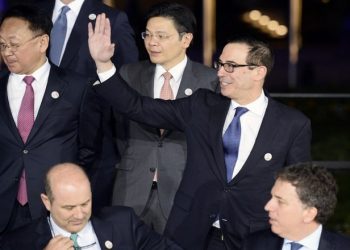 US Secretary of the Treasury Steven Mnuchin (R) waves as he and other participants in the G20 Finance Ministers and Central Bank Governors Meeting pose for the Family photo in Baden-Baden, southern Germany, on March 17, 2017.       
Finance ministers from the world's top nations gather in Germany on March 17, as fears grow of a looming trade war over US President Donald Trump's America First policy. / AFP PHOTO / Thomas Kienzle