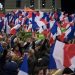 epa05647742 People wave French flags as candidate for the right-wing Les Republicains (LR) party primaries ahead of the 2017 presidential election and former French Prime Minister, Francois Fillon delivers a speech during the nation anthem during a political rally of the second round of the rightwing presidential primary, in Paris, France, 25 November 2016. Francois Fillon took a commanding lead in the two-round primary that is widely expected to decide the country's next leader. The second round will be held on 27 November 2016.  EPA/IAN LANGSDON