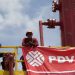 Workers stand in front of a drilling rig at an oil well operated by Venezuela's state oil company PDVSA in Morichal July 28, 2011.  Venezuela received an enviable honor last month: OPEC said it is sitting on the biggest reserves of crude oil in the world -- even more than Saudi Arabia.  But the Venezuelan oil industry is also sitting atop a well of trouble.  Picture taken July 28, 2011.  To match Special Report VENEZUELA/PDVSA  REUTERS/Carlos Garcia Rawlins (VENEZUELA - Tags: ENERGY POLITICS BUSINESS)