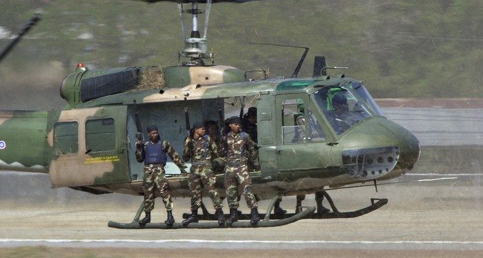 A Thai UH-1 Huey helicopter flies a Thai special operations unit in support of a pilot extraction exercise at the Royal Thai Air Force air show at Korat Air Base, Thailand, during Exercise COPE TIGER 2002.