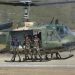 A Thai UH-1 Huey helicopter flies a Thai special operations unit in support of a pilot extraction exercise at the Royal Thai Air Force air show at Korat Air Base, Thailand, during Exercise COPE TIGER 2002.