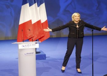 Far-right leader presidential candidate Marine Le Pen acknowledges applauses as she arrives as to a conference in Lyon, France, Sunday, Feb. 5, 2017. Marine Le Pen, the far-right presidential candidate, unveiled her platform Saturday at the start of a weekend conference, envisioning a thriving nation "made in France. (AP Photo/Michel Euler)