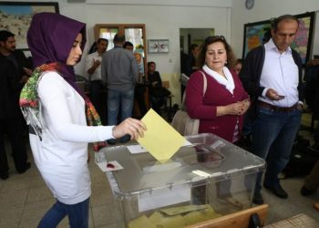 A Turkish woman casts her ballot as she votes in Turkey's general election at a polling station  in a primary school in Ankara on June 7, 2015. Turkey Turkish voters went to the polls on June 7 in a bitterly-contested election set to determine whether President Recep Tayyip Erdogan can tighten his increasingly controversial grip on the country. The legislative election is taking place under the shadow of violence after two people were killed and dozens more wounded in an attack on a rally of the pro-Kurdish People's Democratic Party (HDP) in the southeastern city of Diyarbakir two days prior. AFP PHOTO / ADEM ALTAN