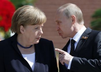 File photo of Russian President Vladimir Putin speaking with German Chancellor Angela Merkel