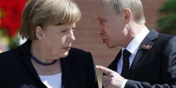 File photo of Russian President Vladimir Putin speaking with German Chancellor Angela Merkel