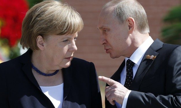 File photo of Russian President Vladimir Putin speaking with German Chancellor Angela Merkel