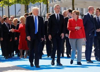 (L-R) U.S. President Donald Trump, NATO Secretary General Jens Stoltenberg and German Chancellor Angela Merkel gather with NATO member leaders to pose for a family picture before the start of their summit in Brussels, Belgium, May 25, 2017.REUTERS/Jonathan Ernst