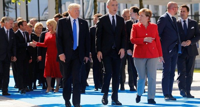 (L-R) U.S. President Donald Trump, NATO Secretary General Jens Stoltenberg and German Chancellor Angela Merkel gather with NATO member leaders to pose for a family picture before the start of their summit in Brussels, Belgium, May 25, 2017.REUTERS/Jonathan Ernst