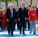 (L-R) U.S. President Donald Trump, NATO Secretary General Jens Stoltenberg and German Chancellor Angela Merkel gather with NATO member leaders to pose for a family picture before the start of their summit in Brussels, Belgium, May 25, 2017.REUTERS/Jonathan Ernst