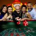 Excited friends gambling at craps table in casino