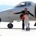 Johan Tarculovski, center, accompanied by his wife Sonja Tarculovska, right, is welcomed by his children upon his arrival at "Alexander the Great" airport near Macedonia's capital Skopje, on Thursday, April 11, 2013. Couple of thousands of people have gathered at the airport on Tuesday to welcome the return of Johan Tarculovski, the only Macedonian convicted by The Hague tribunal for war crimes committed during 2001 ethnic conflict. (AP Photo/(Boris Grdanoski)