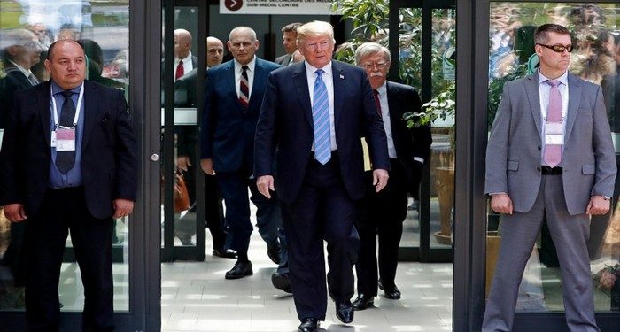 U.S. President Donald Trump is followed by National Security Advisor John Bolton (R) as he departs from the G7 summit in the Charlevoix city of La Malbaie, Quebec, Canada, June 9, 2018. REUTERS/Yves Herman