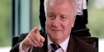 German Interior Minister Horst Seehofer points prior to the weekly cabinet meeting at the chancellery in Berlin, Germany, Friday, July 6, 2018. (AP Photo/Michael Sohn)