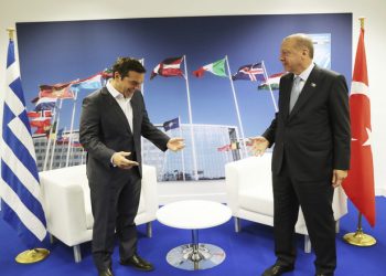 Turkey's President Recep Tayyip Erdogan, right, jokes with Greece's Prime Minister Alexis Tsipras, prior to their talks on the sidelines of a summit of heads of state and government at NATO headquarters in Brussels, Thursday, July 12, 2018.  NATO leaders gathered in Brussels for a two-day summit to discuss subjects including Russia, Iraq and their mission in Afghanistan. (Presidency Press Service via AP, Pool)