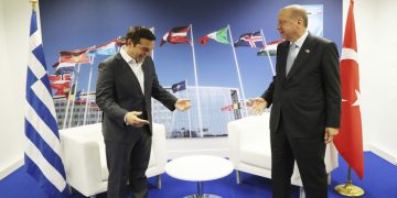 Turkey's President Recep Tayyip Erdogan, right, jokes with Greece's Prime Minister Alexis Tsipras, prior to their talks on the sidelines of a summit of heads of state and government at NATO headquarters in Brussels, Thursday, July 12, 2018.  NATO leaders gathered in Brussels for a two-day summit to discuss subjects including Russia, Iraq and their mission in Afghanistan. (Presidency Press Service via AP, Pool)