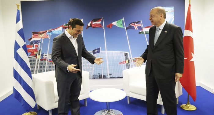 Turkey's President Recep Tayyip Erdogan, right, jokes with Greece's Prime Minister Alexis Tsipras, prior to their talks on the sidelines of a summit of heads of state and government at NATO headquarters in Brussels, Thursday, July 12, 2018.  NATO leaders gathered in Brussels for a two-day summit to discuss subjects including Russia, Iraq and their mission in Afghanistan. (Presidency Press Service via AP, Pool)