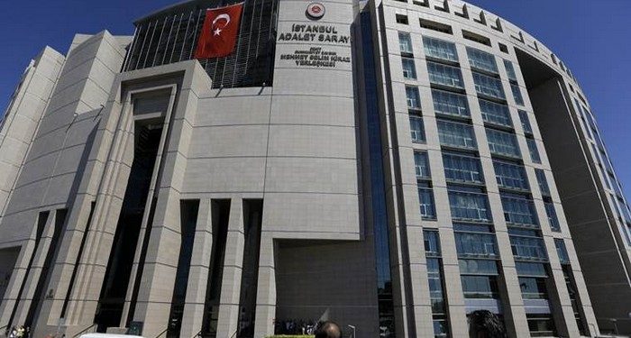 People stand outside a courthouse building in Istanbul, on Monday, Aug. 15, 2016. Police teams on Monday apprehended 136 personnel in operations conducted at three Istanbul courthouses as part of an investigation into the July 15 abortive coup. (AP Photo/Thanassis Stavrakis)