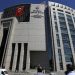 People stand outside a courthouse building in Istanbul, on Monday, Aug. 15, 2016. Police teams on Monday apprehended 136 personnel in operations conducted at three Istanbul courthouses as part of an investigation into the July 15 abortive coup. (AP Photo/Thanassis Stavrakis)