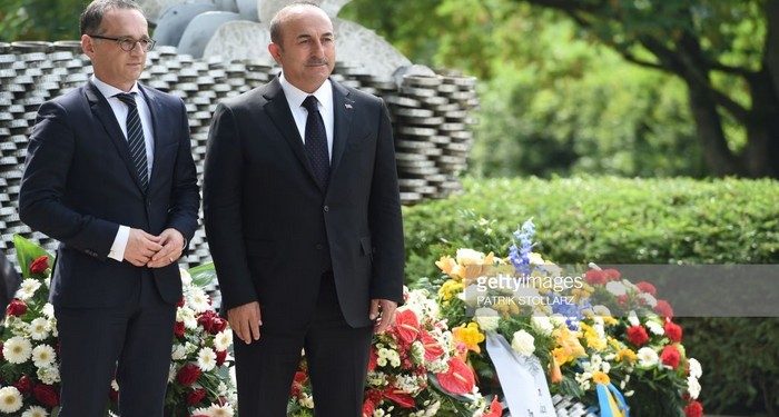 Turkish Foreign Minister Mevlut Cavusoglu (R) and German Foreign Minister Heiko Maas take part on May 29, 2018 in a ceremony at a memorial in Solingen to mark the 25th anniversary of an arson attack that killed five people of Turkish origin. - Germany remembered the five ethnic Turkish victims of a murderous neo-Nazi arson attack 25 years ago, amid warnings of resurgent German xenophobia and simmering bilateral tensions ahead of Turkish elections. (Photo by PATRIK STOLLARZ / AFP)        (Photo credit should read PATRIK STOLLARZ/AFP/Getty Images)