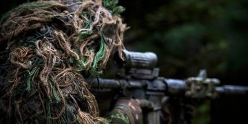 A member of the sniper team watches for the enemy during Exercise ALLIED SPIRIT V as part of Operation REASSURANCE on October 6, 2016. (Cpl Jay Ekin/DND-MDN Canada)