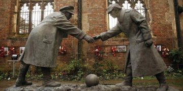 A resin sculpture, called "All Together Now", by artist Andrew Edwards, and depicting the Christmas Day football match between German and British soldiers fighting on the front line in World War One in 1914, is seen after being unveiled in the remains of St Luke's Church in Liverpool, northern England in this December 15, 2014 file photo. REUTERS/Phil Noble/Files