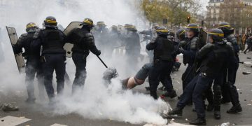 French CRS riot police apprehend a demonstrator during clashes near the Place de la Republique after the cancellation of a planned climate march following shootings in the French capital, ahead of the World Climate Change Conference 2015 (COP21), in Paris, France, November 29, 2015.     REUTERS/Eric Gaillard     - RTX1WCS1