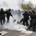 French CRS riot police apprehend a demonstrator during clashes near the Place de la Republique after the cancellation of a planned climate march following shootings in the French capital, ahead of the World Climate Change Conference 2015 (COP21), in Paris, France, November 29, 2015.     REUTERS/Eric Gaillard     - RTX1WCS1