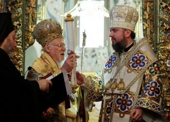 Ecumenical Patriarch Bartholomew I hands Tomos, a decree granting Ukraine church independence, to Metropolitan Epifaniy, head of the Orthodox Church of Ukraine, after the Epiphany mass at the Patriarchal Cathedral of St. George in Istanbul, Turkey January 6, 2019. REUTERS/Murad Sezer