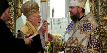 Ecumenical Patriarch Bartholomew I hands Tomos, a decree granting Ukraine church independence, to Metropolitan Epifaniy, head of the Orthodox Church of Ukraine, after the Epiphany mass at the Patriarchal Cathedral of St. George in Istanbul, Turkey January 6, 2019. REUTERS/Murad Sezer