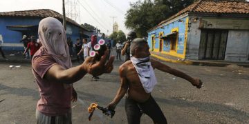 Opposition demonstrators clash with the Bolivarian National Guard in Urena, Venezuela, near the border with Colombia, Saturday, Feb. 23, 2019. Venezuela's National Guard fired tear gas on residents clearing a barricaded border bridge between Venezuela and Colombia on Saturday, heightening tensions over blocked humanitarian aid that opposition leader Juan Guaido has vowed to bring into the country over objections from President Nicolas Maduro(AP Photo/Fernando Llano)