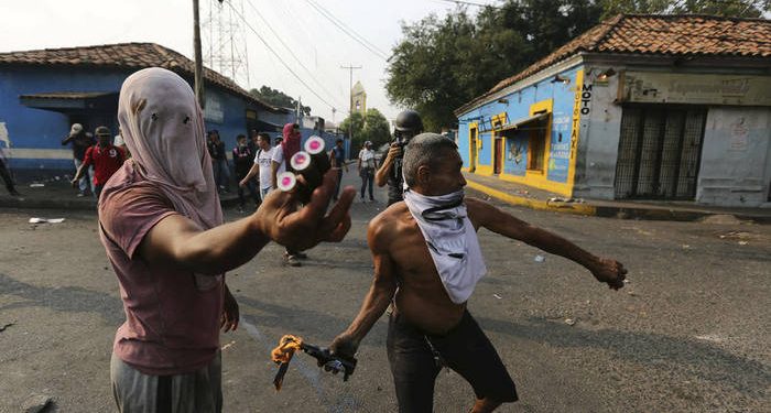 Opposition demonstrators clash with the Bolivarian National Guard in Urena, Venezuela, near the border with Colombia, Saturday, Feb. 23, 2019. Venezuela's National Guard fired tear gas on residents clearing a barricaded border bridge between Venezuela and Colombia on Saturday, heightening tensions over blocked humanitarian aid that opposition leader Juan Guaido has vowed to bring into the country over objections from President Nicolas Maduro(AP Photo/Fernando Llano)