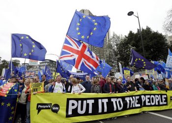 Demonstrators hold a banner during a Peoples Vote anti-Brexit march in London, Saturday, March 23, 2019. The march, organized by the People's Vote campaign is calling for a final vote on any proposed Brexit deal. This week the EU has granted Britain's Prime Minister Theresa May a delay to the Brexit process. (AP Photo/Kirsty Wigglesworth)